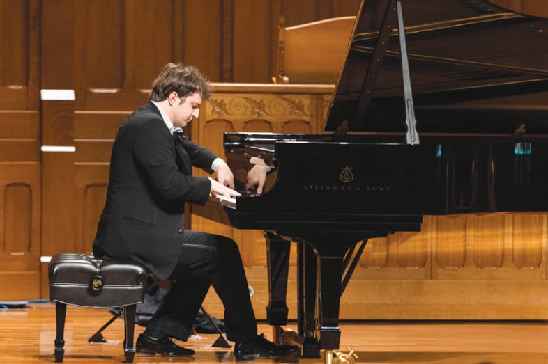 Kenny Broberg playing a grand piano