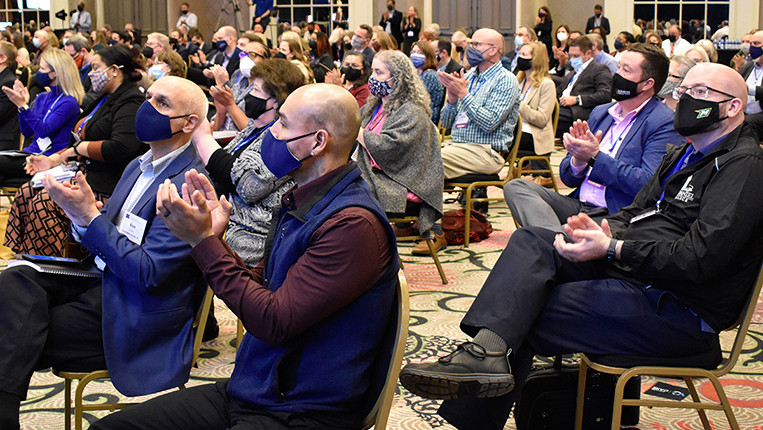 participants seated and clapping