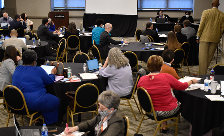 Participants seated at roundtables