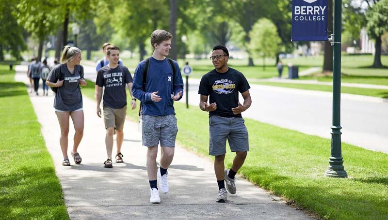 Berry College students walking on a sidewalk talking to each other