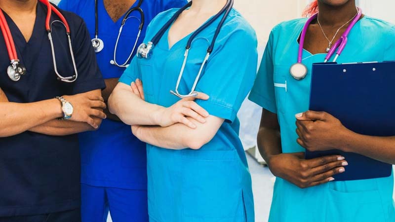 Four nursing students in scrubs