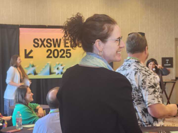 A woman smiling candidly over her shoulder