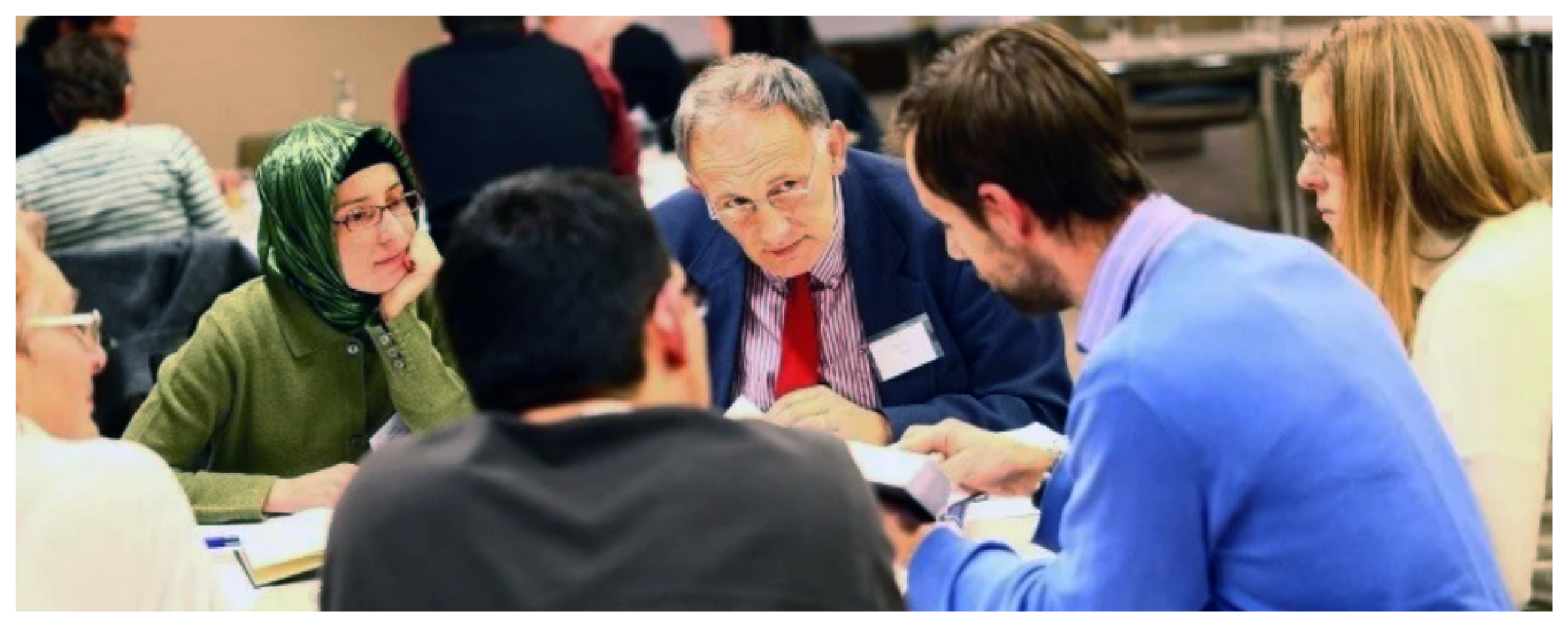 Individuals seated at a table in discussion