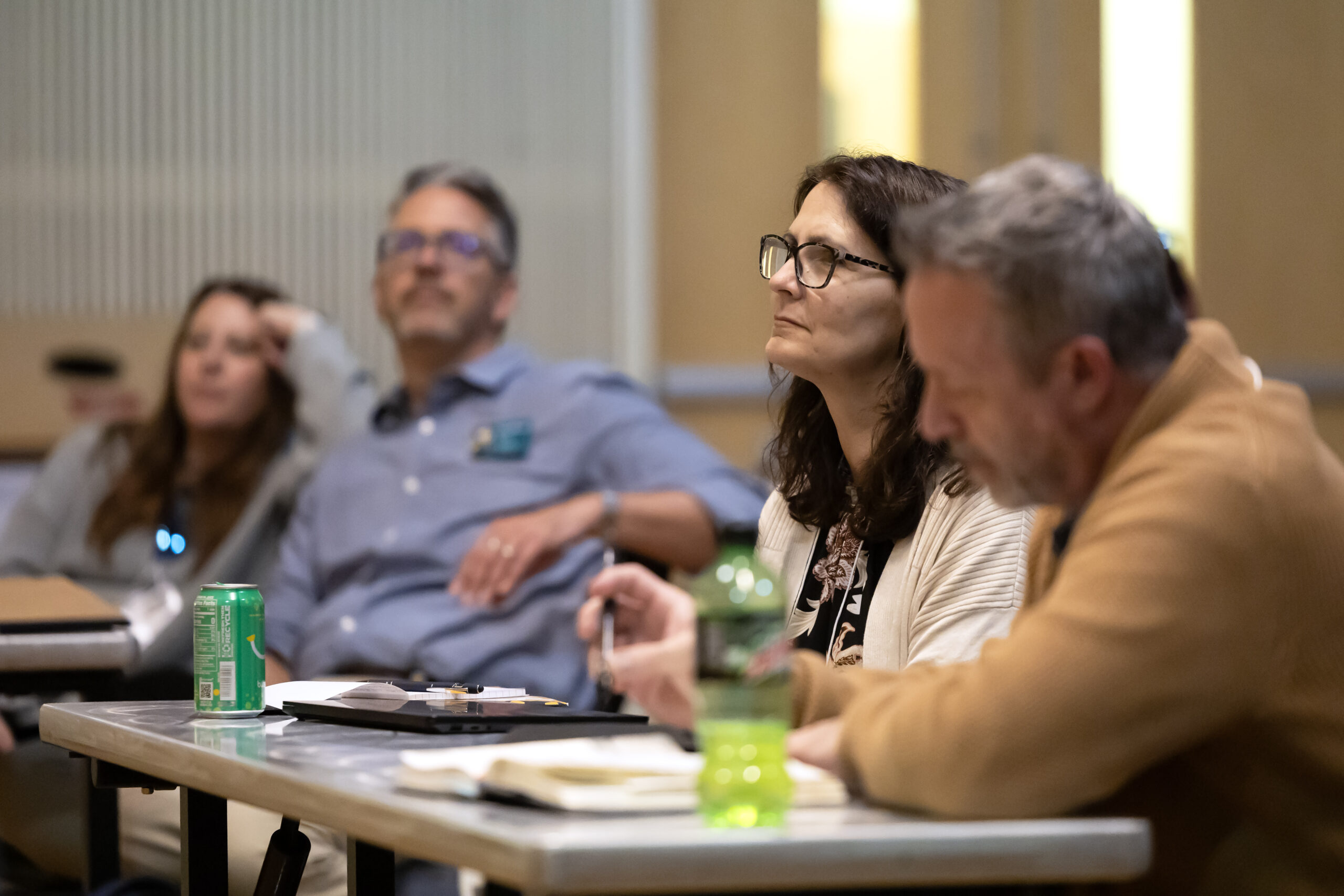 A woman looking up from her notes during the 2025 NetVUE regional gathering at Pacific Lutheran University
