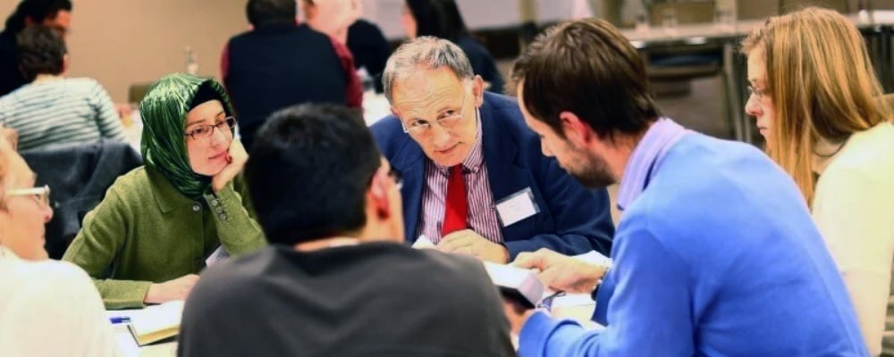 A group of individuals around a table in discussion