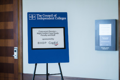 Session sign on an easel in front of a meeting room listing the sponsors for that session: BHDP and CapEd