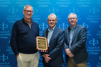Three sponsors standing with award received for long-time sponsorship with CIC