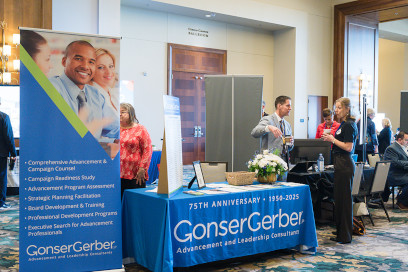 Sponsor from Gonser Gerber speaking with participant at his booth