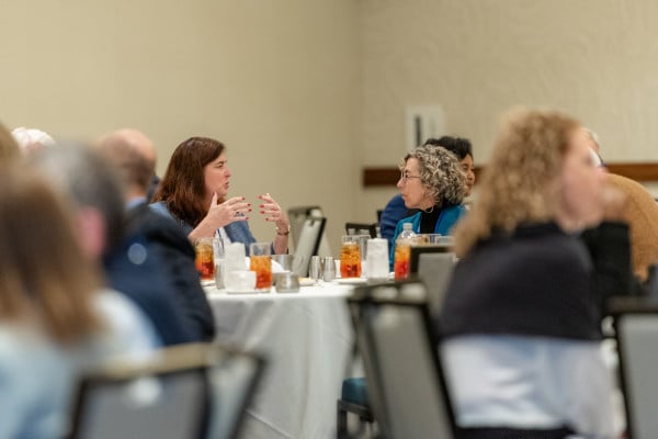 Participants discuss topics at roundtables