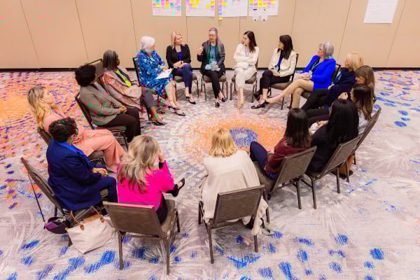 17 participants seated in chairs arranged in a circle