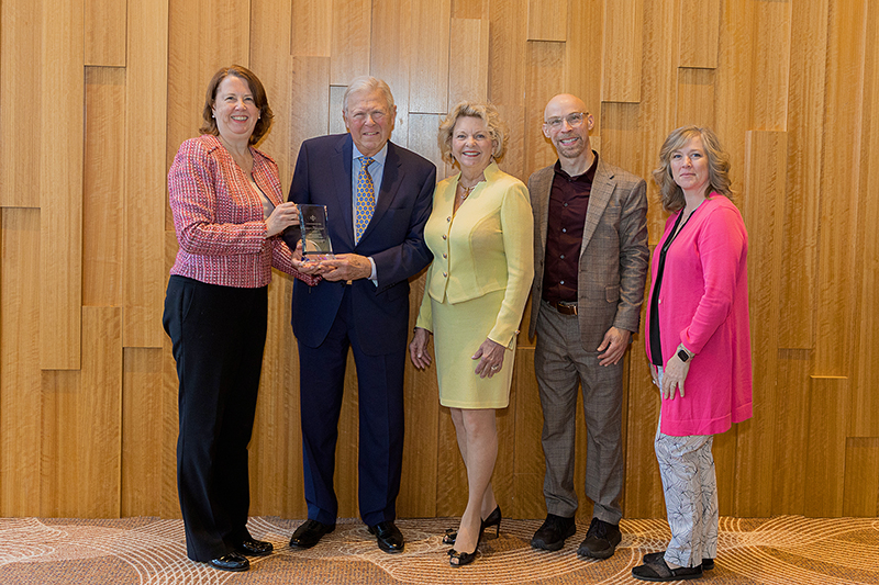 Award recipients posing with glass award with State Council and CIC staff