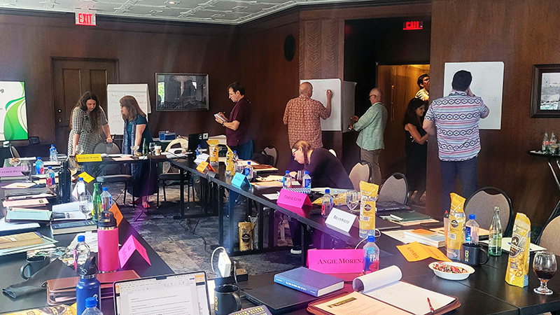 Participants write on posters hanging on walls