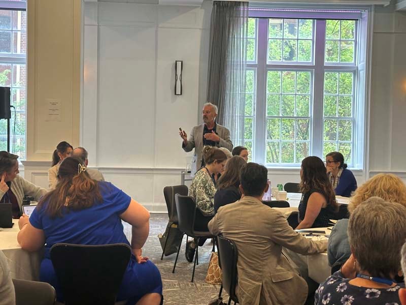Participant stands to ask a question
