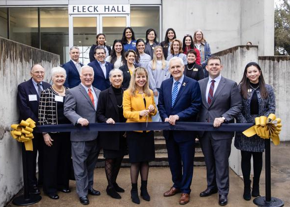 University and city officials pose for ribbon cutting ceremony