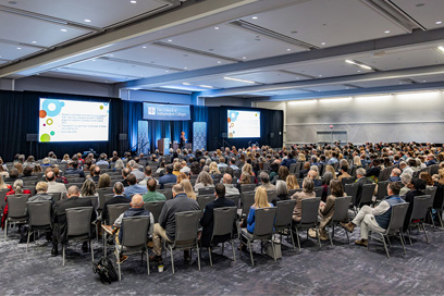 rear view of packed seated audience for plenary session