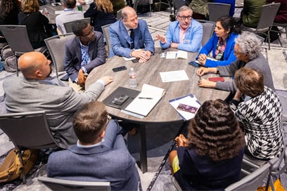 Presenters sharing ideas at a roundtable discussion