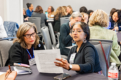 The participants look at a handout during a roundtable discussion