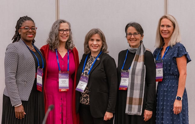 Five female participants pose for photo