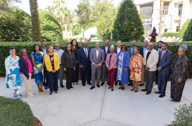 group photo of presidents standing outside in a garden