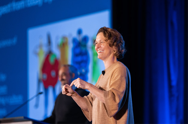 Two plenary speakers presenting on stage
