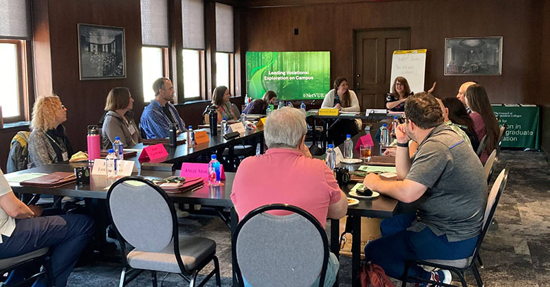 Participants and speakers seated around a hollow square