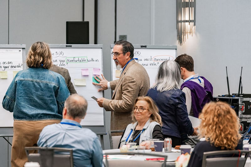 Spouses and partners writing on whiteboards