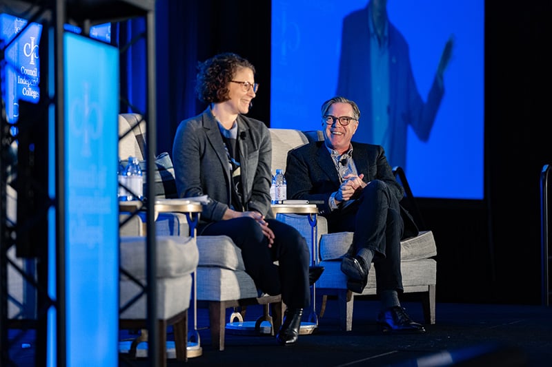 Emily Levine and Mitchell Stevens sitting on chairs on stage