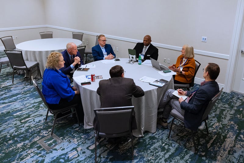 7 presidents seated around a roundtable