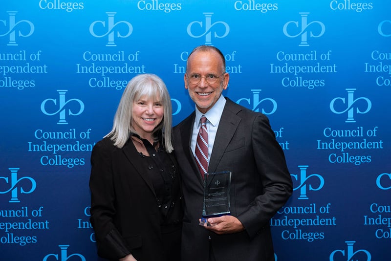 Marjorie Hass stands with Michael Goeke holding his award