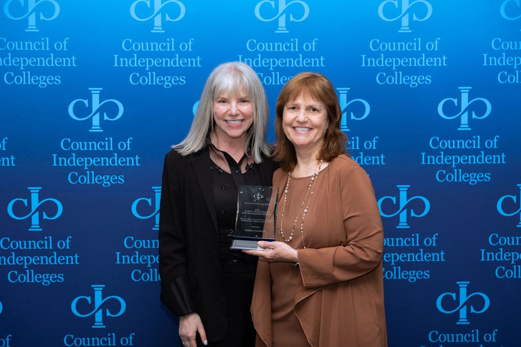 Marjorie Hass poses with Sarah Flanagan holding her award
