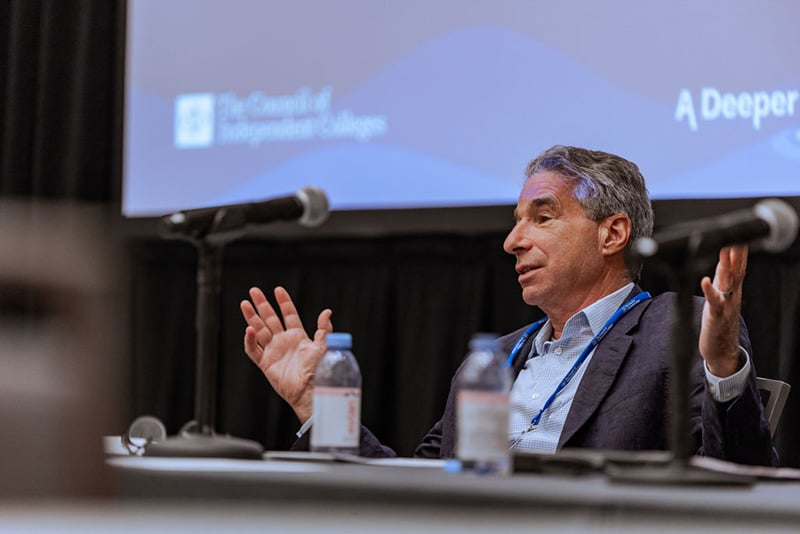 Speaker gesture with hands while seated at head table