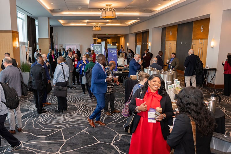 Participants speak with sponsors in exhibit hall
