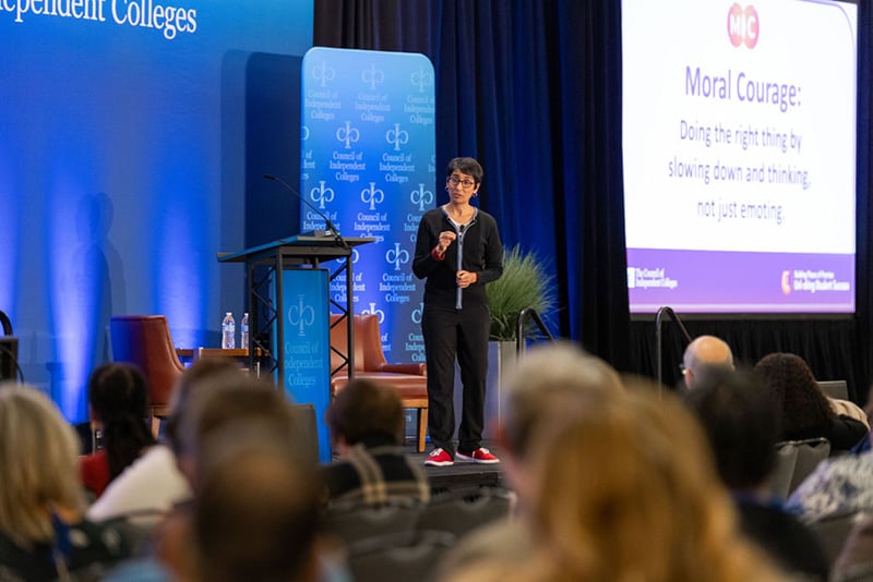 Irshad Manji presents from stage before seated audience