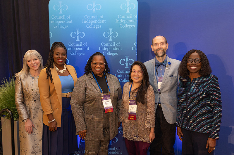 Marjorie Hass and Titi Ufomata pose with the four speakers from the closing plenary panel