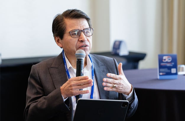 Speaker presents while holding microphone