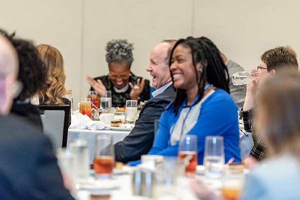 Seated participants laughing