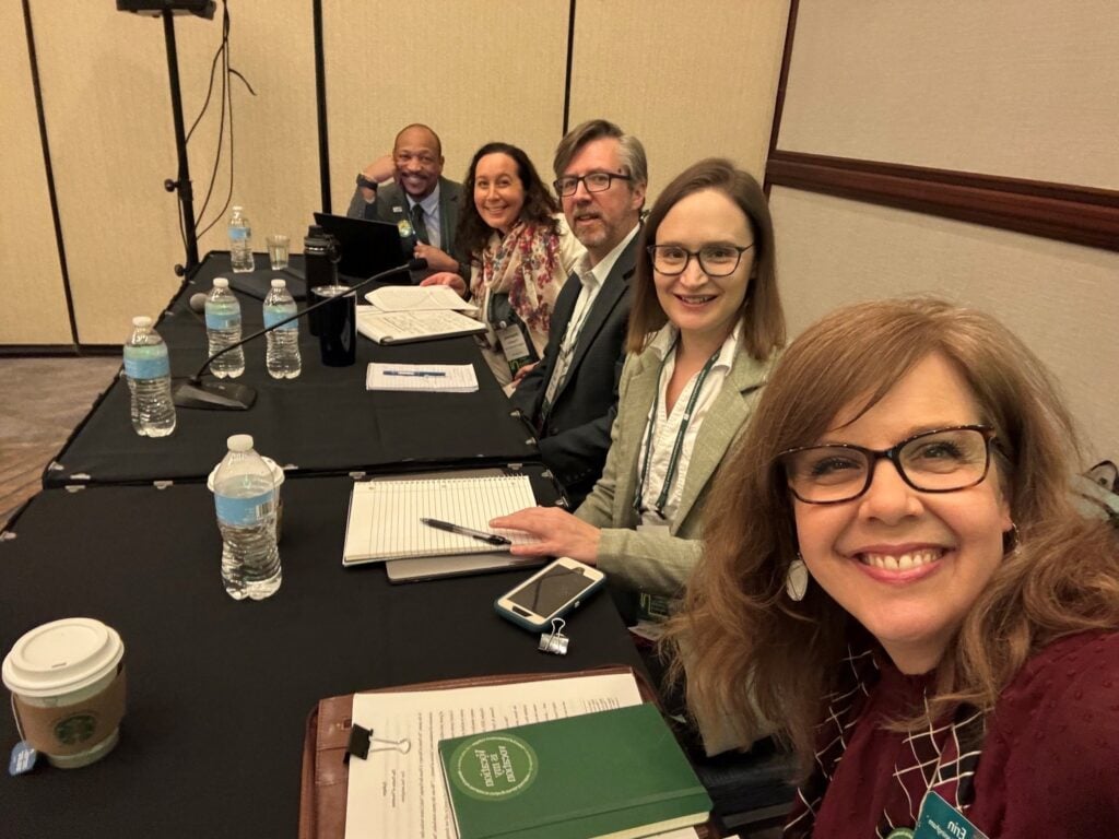 Five presenters take a selfie at the NetVUE conference in March 2026.