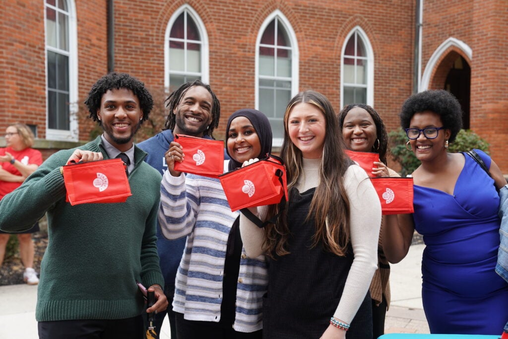 Six students on Otterbein University's campus smile at the camera.