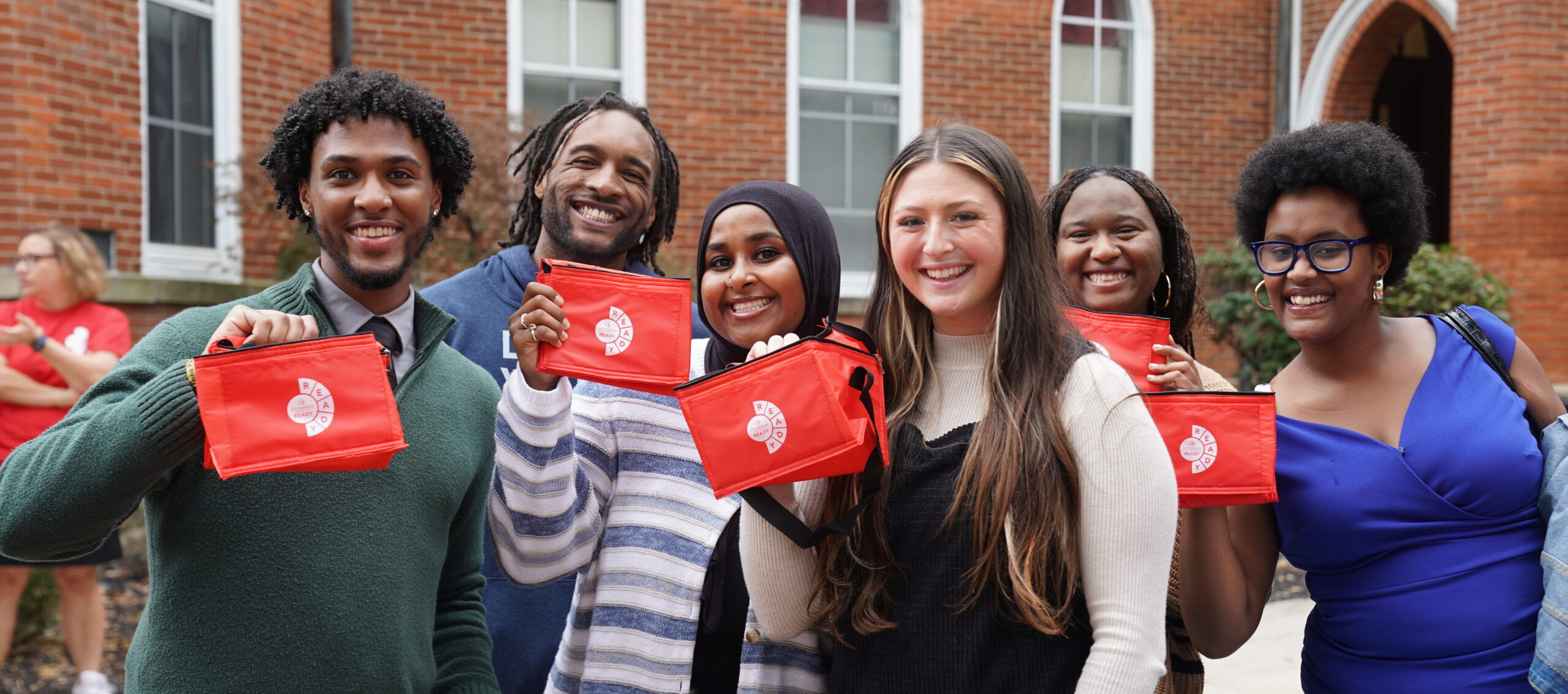 Six students on Otterbein University's campus smile at the camera.