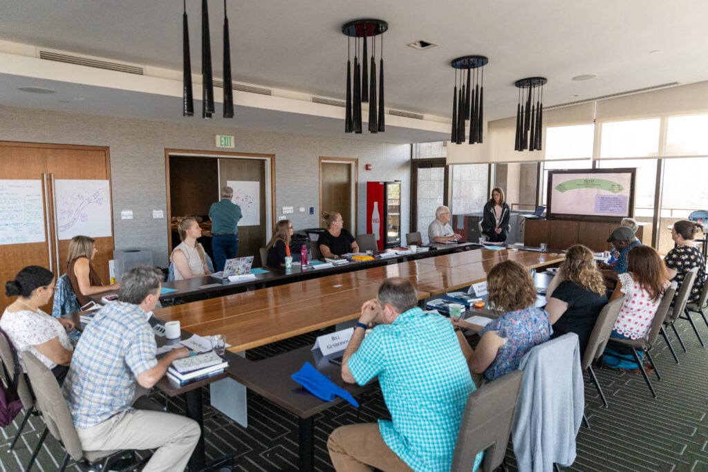Seminar participants seated around a conference table