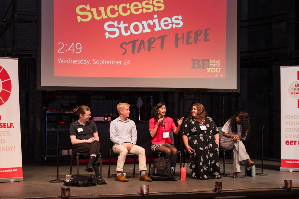 Five panelists speak on a stage at Otterbein University.